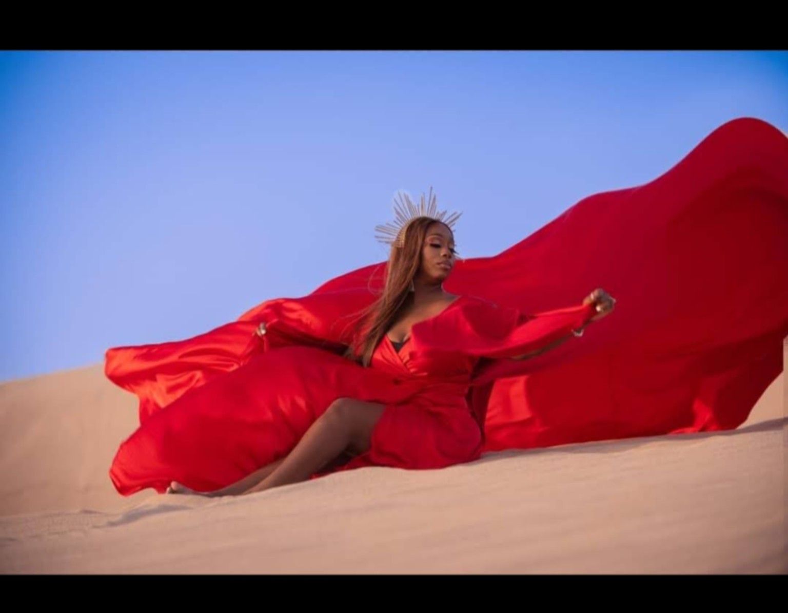 Janice in a flowing red dress in the desert