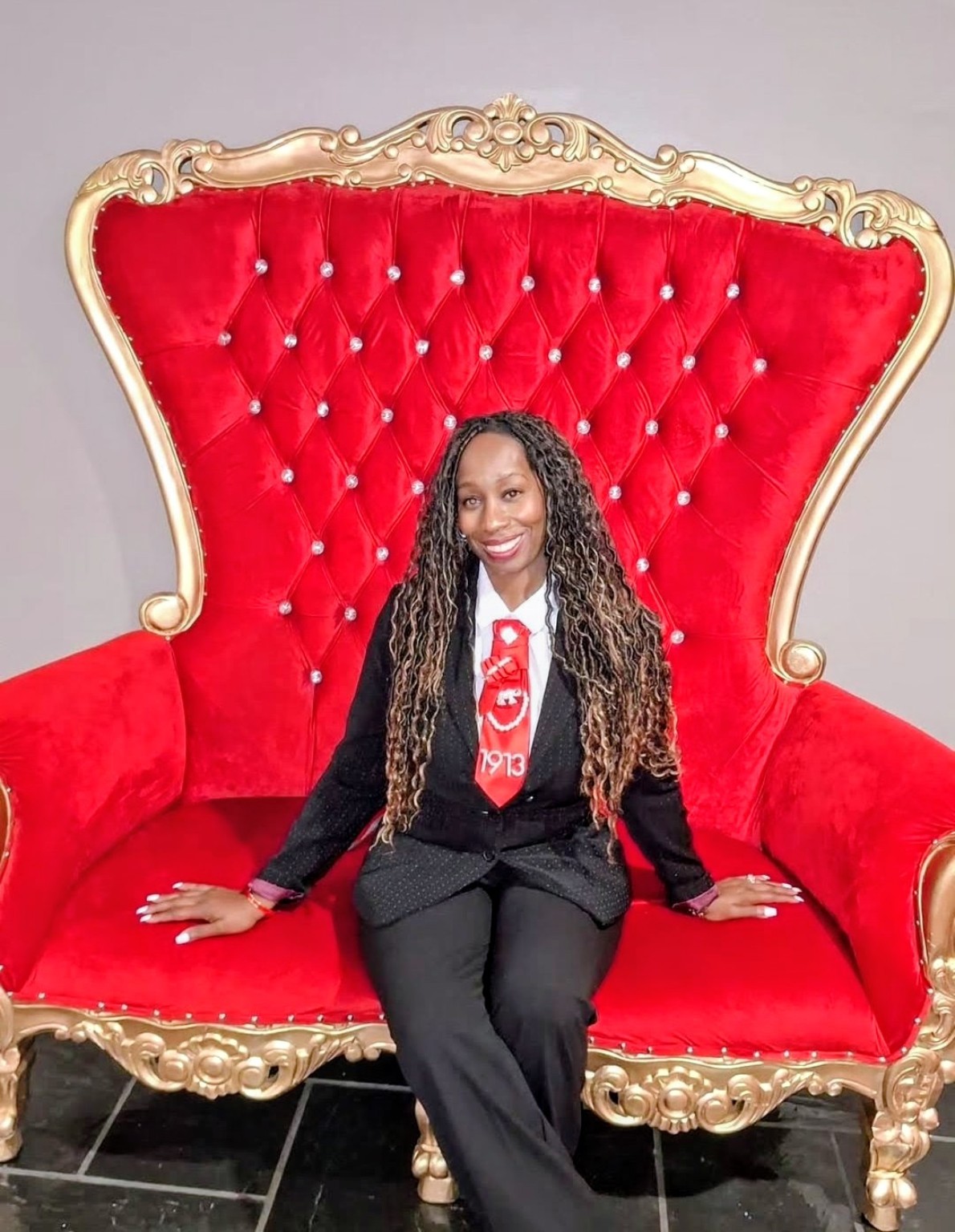 Janice seated in a red chair