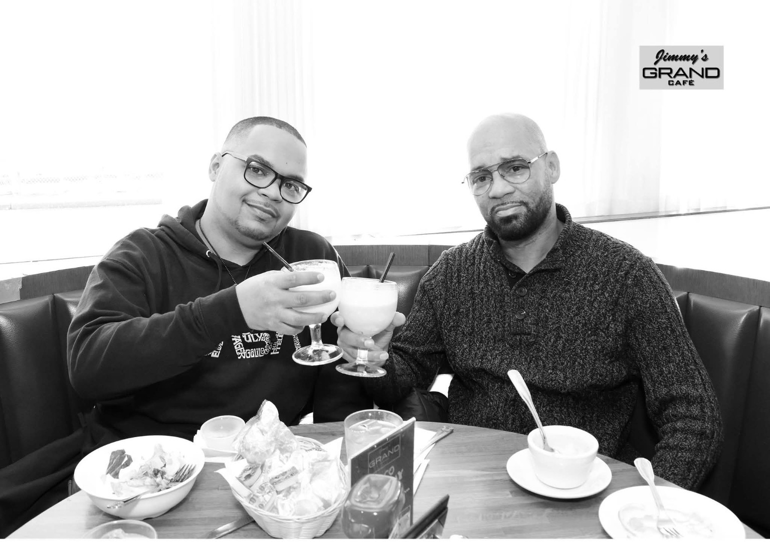 Kyle and Jamel toasting in black and white